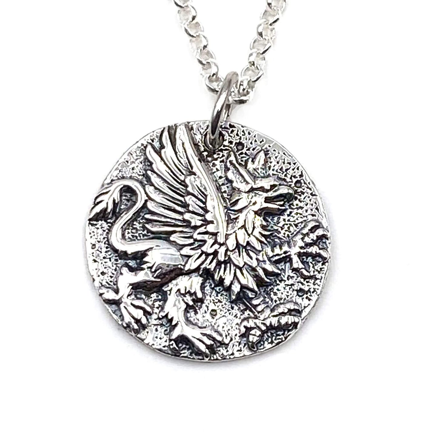 Detailed view of a Greek Mythology Griffin pendant with a eagles head, wings and a lions body.