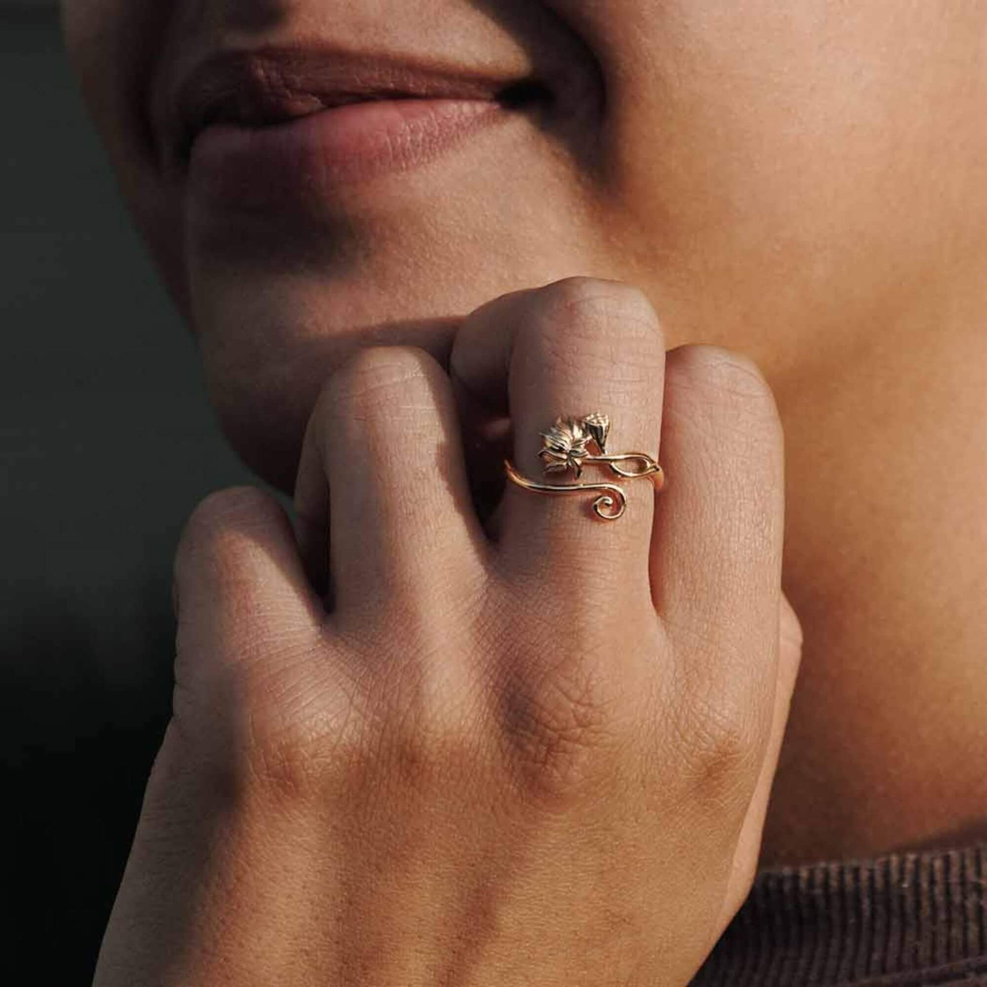 Womens hand showing the size reference that feels petite and dainty with soft swirls and detailed floral designs.