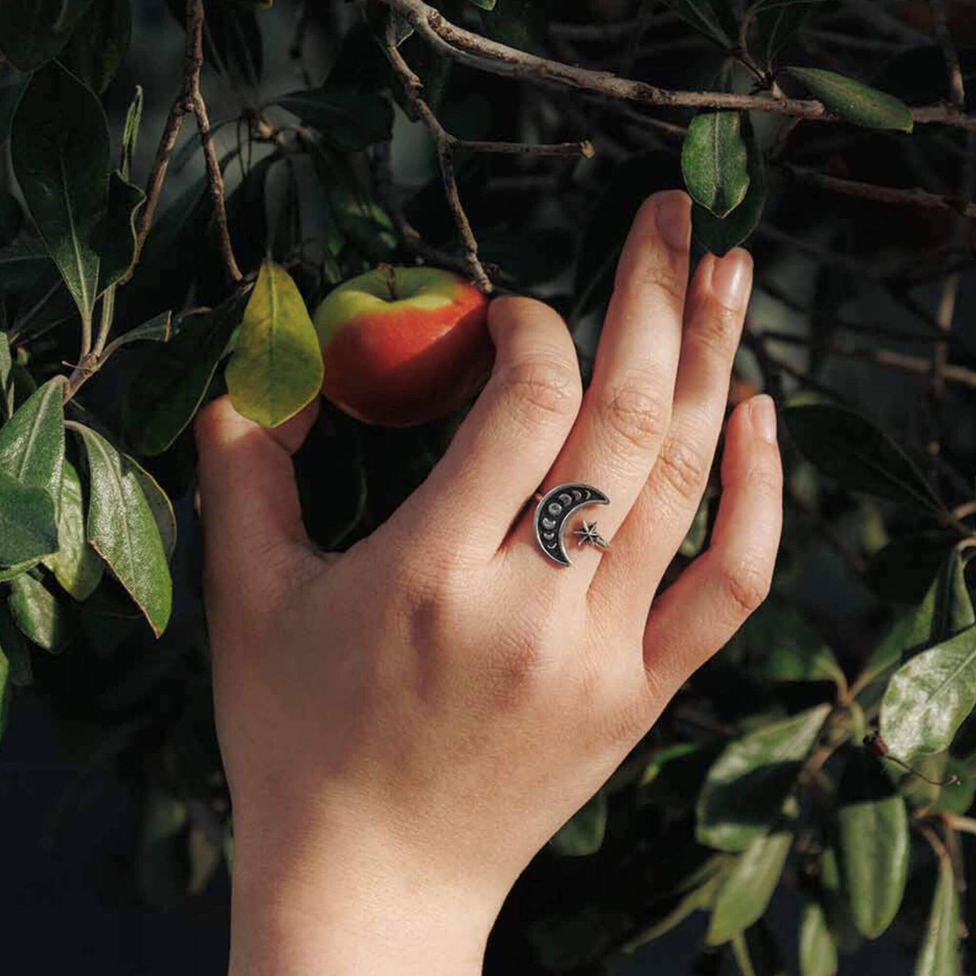 Womens model hand showing the size of the crescent moon on the finger.