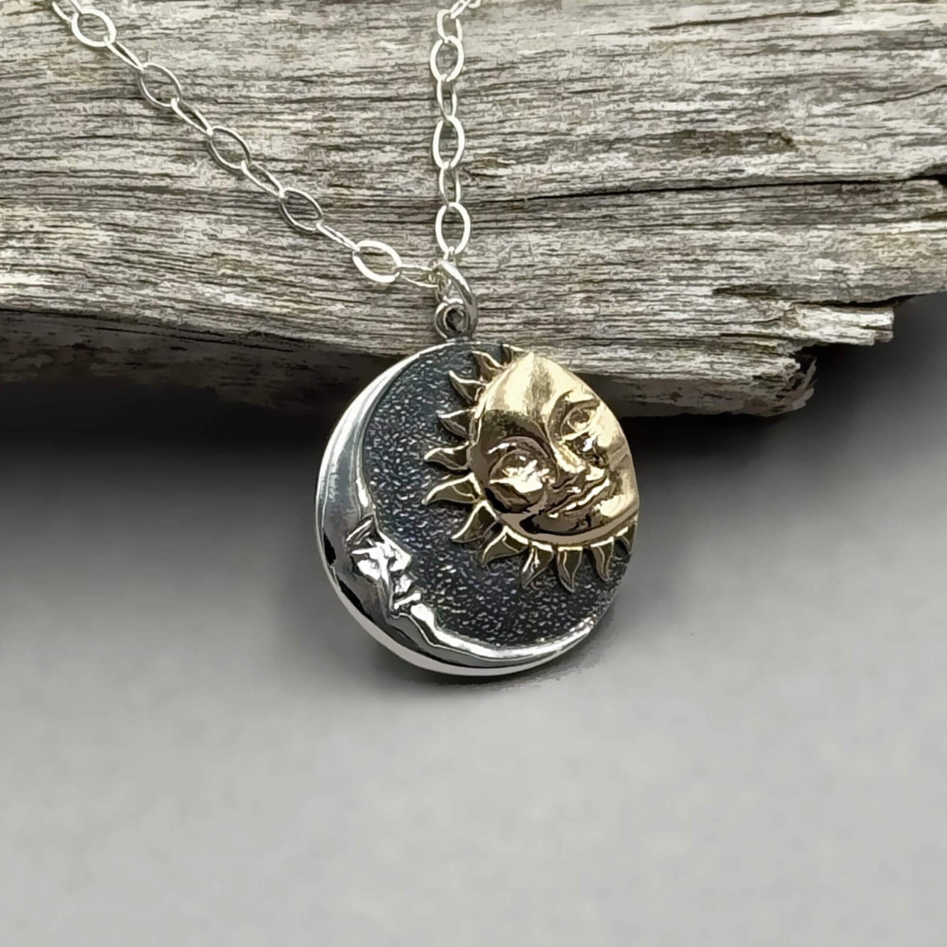 Round shaped silver mixed metal sun and moon pendant on a sterling silver chain.