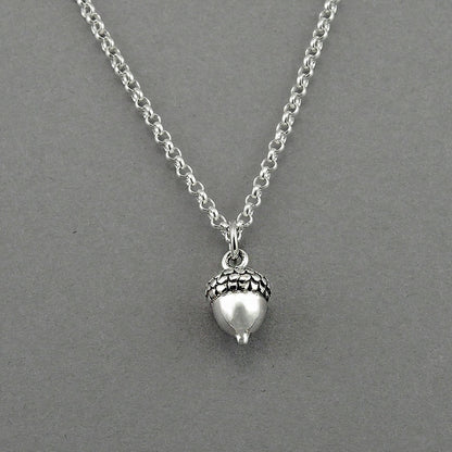 Acorn shaped silver tiny charm on a sterling silver chain.