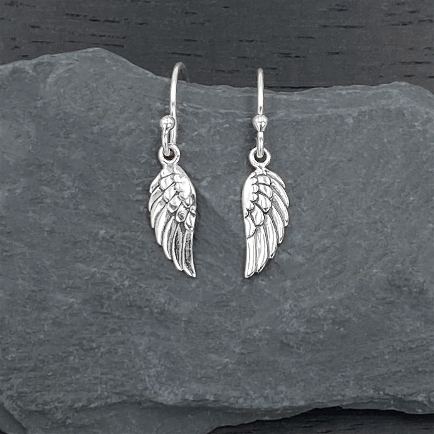 Sterling silver earrings on silver hook ear wires with a detailed angel wing design.