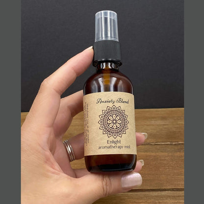 Aroma mister for essential oil blend showing the size in hand for 2oz amber glass bottle. 