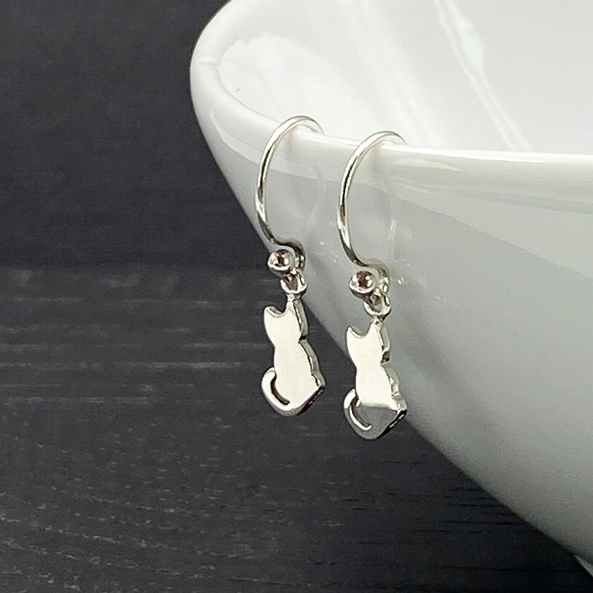 Sterling silver dangle earrings on silver hook ear wires with a charming 2D cat  design.