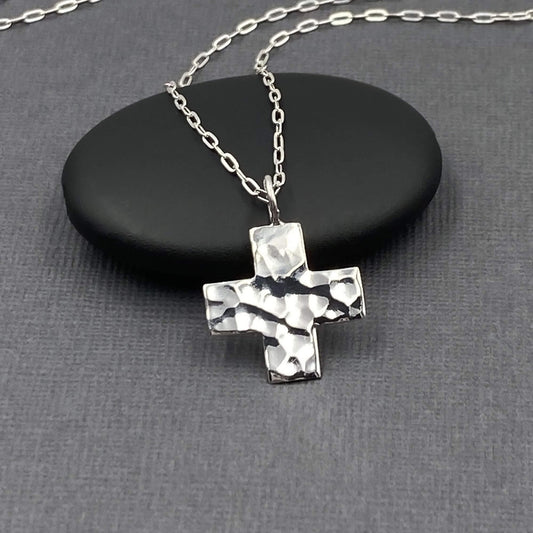 Hand hammered shiny sterling silver cross pendant on a chain.  The christian cross is a square chunky style. Small cross charm. 