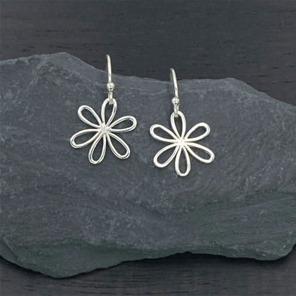 Charming sterling silver earrings on silver hook ear wires with a modern daisy design.