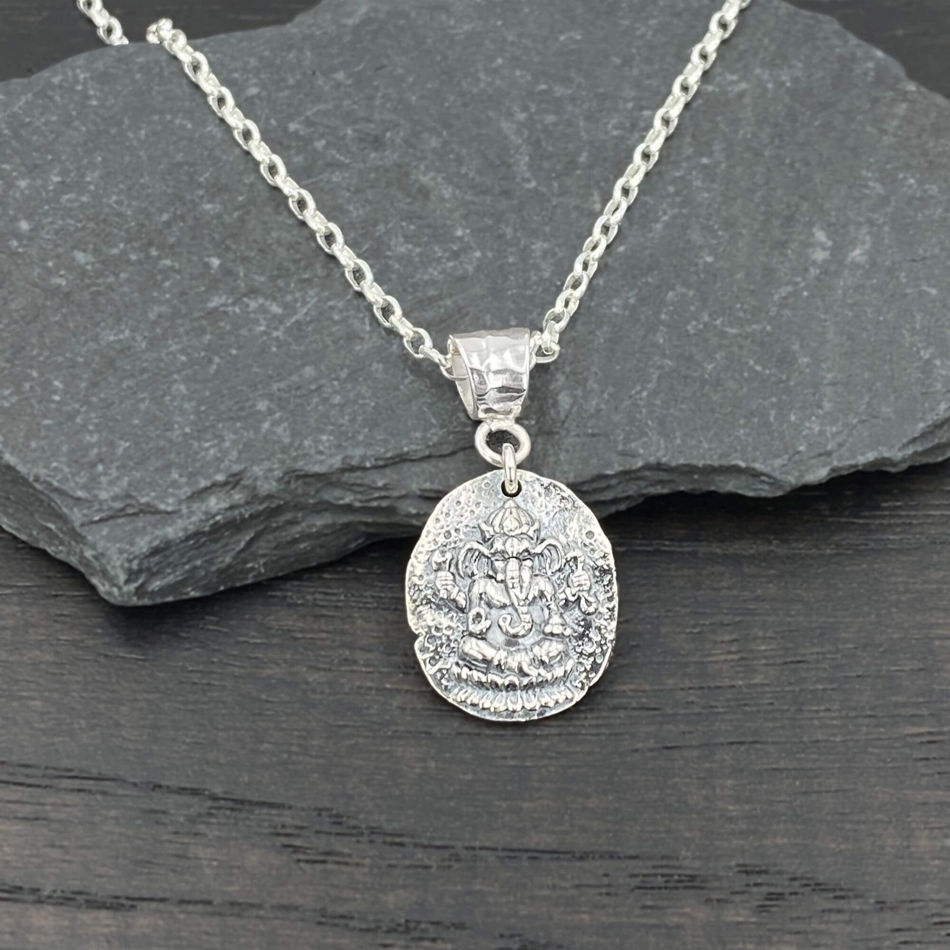 Oval shaped silver ganesha coin pendant on a sterling silver chain for women. Yoga inspired jewelry. 