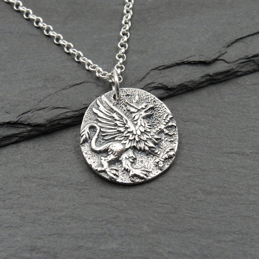 Round coin shaped silver Griffin as part eagle and part lion pendant on a sterling silver chain. Greek mythology charm.