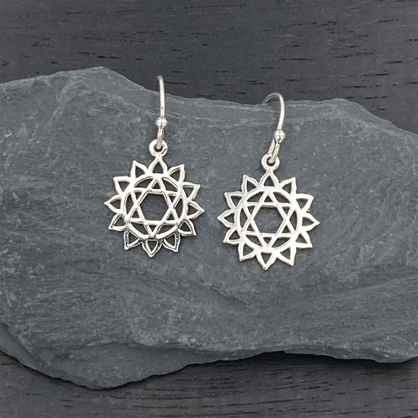 Sterling silver elegant earrings on silver hook ear wires with a heart chakra design.