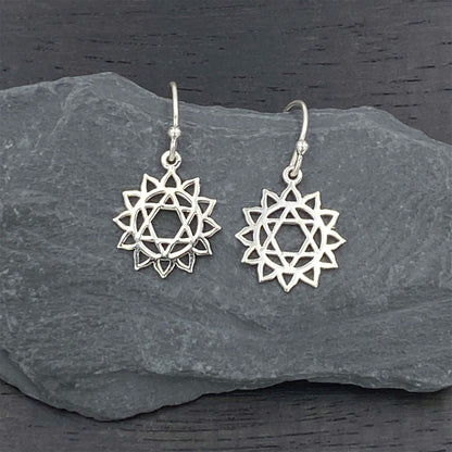 Sterling silver elegant earrings on silver hook ear wires with a heart chakra design.