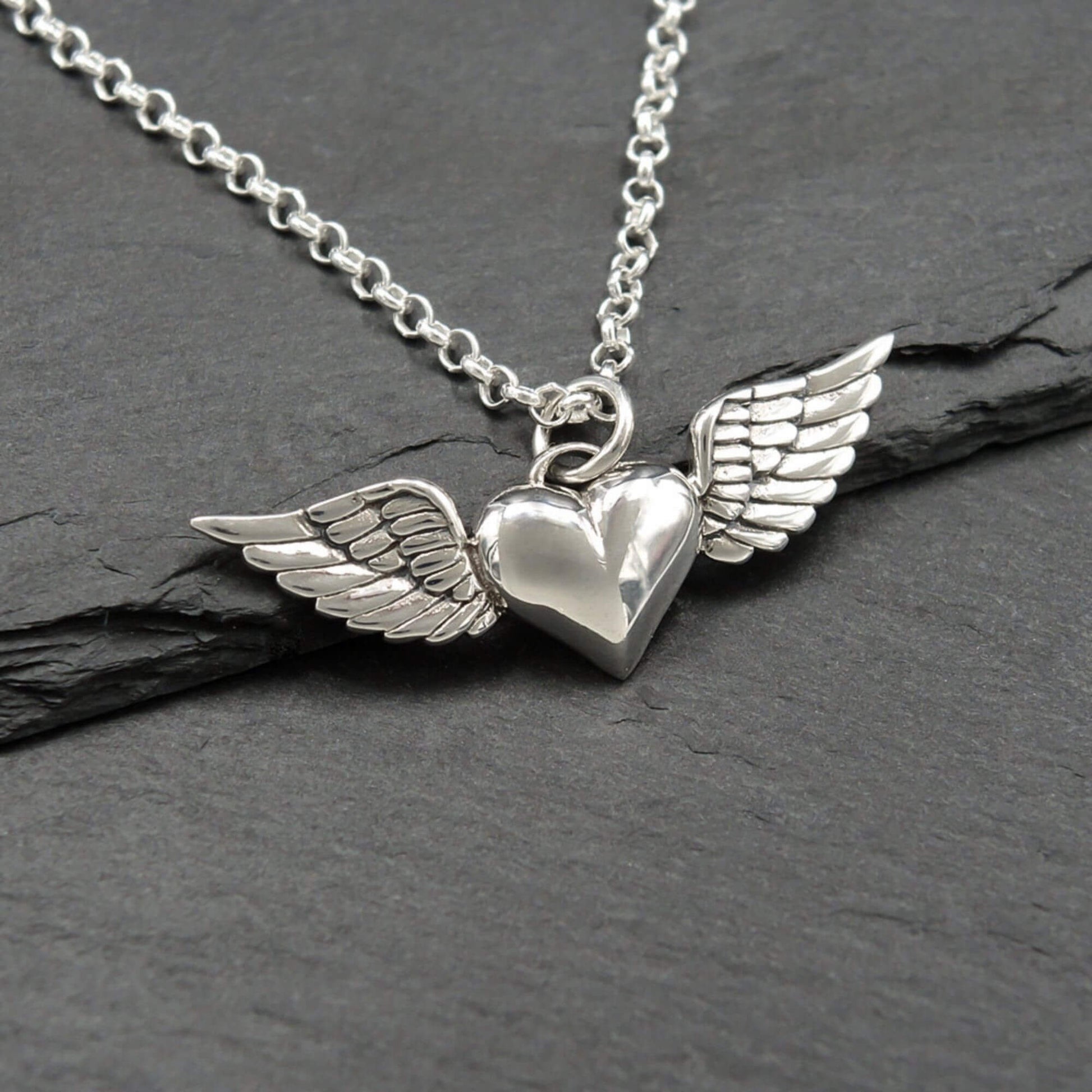 Winged heart shaped sterling silver  charm on a sterling silver chain.