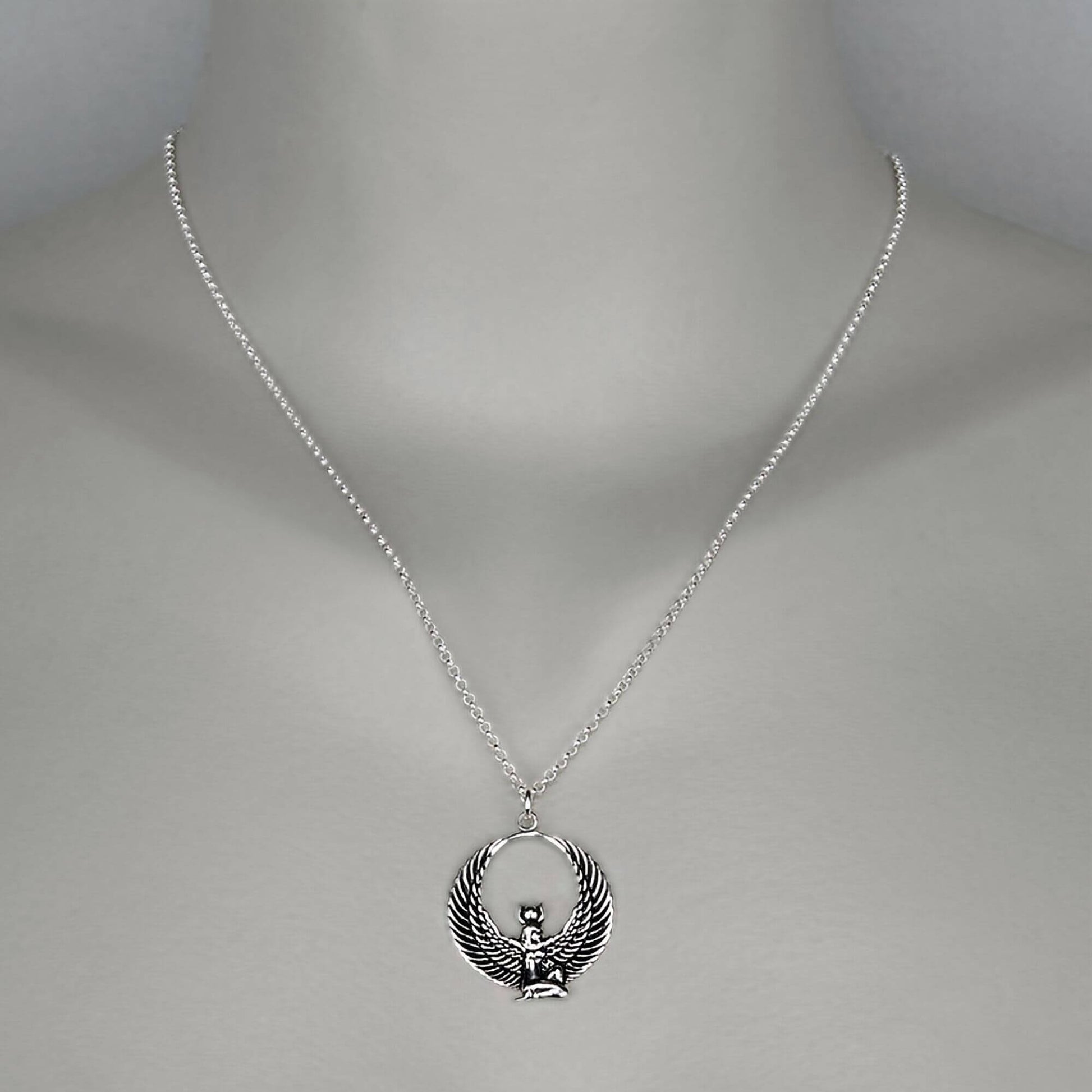 A woman wearing a sterling silver chain necklace with a trendy Goddess  pendant in sterling silver.