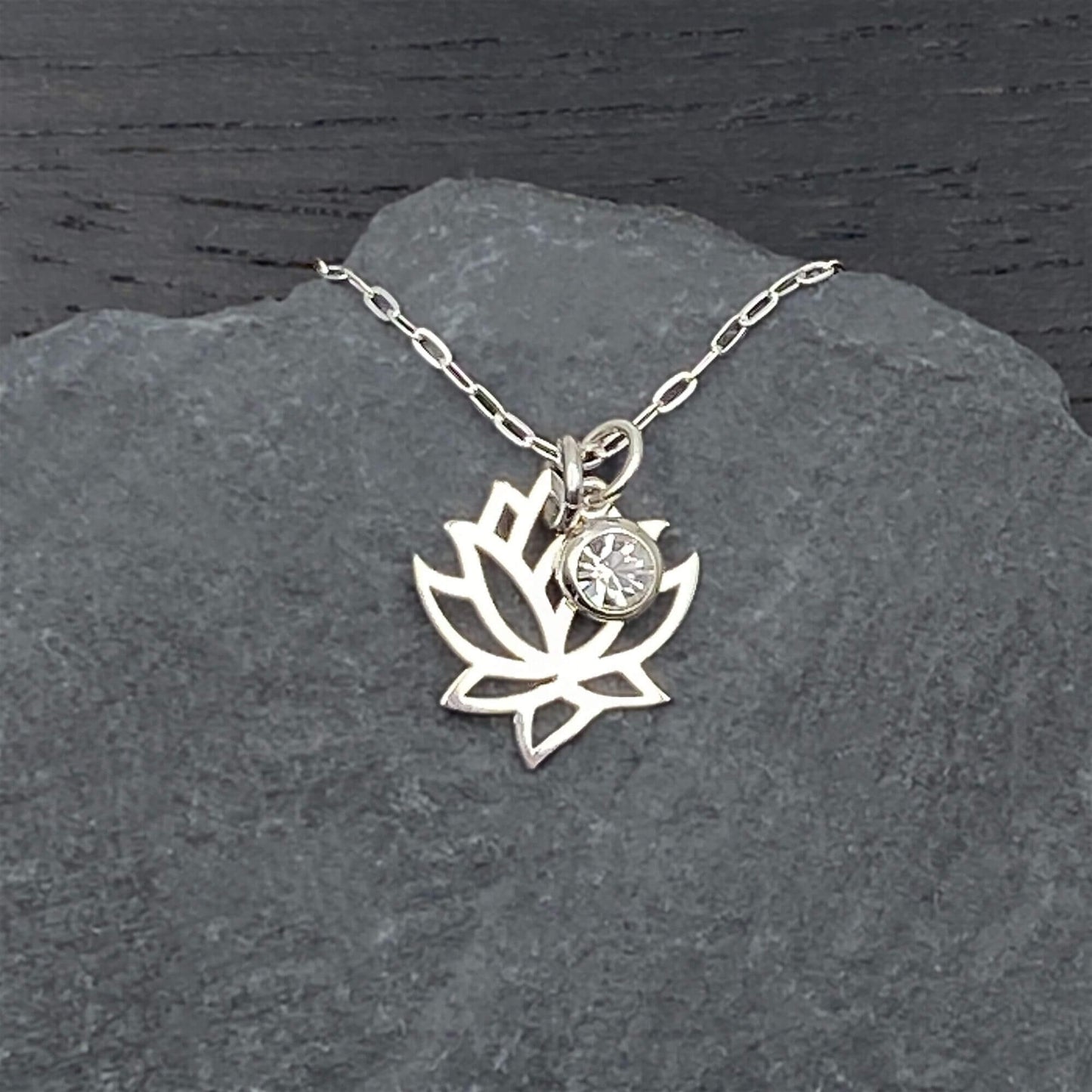 Openwork lotus flower and accent crystal dangle  charm on a sterling silver chain.