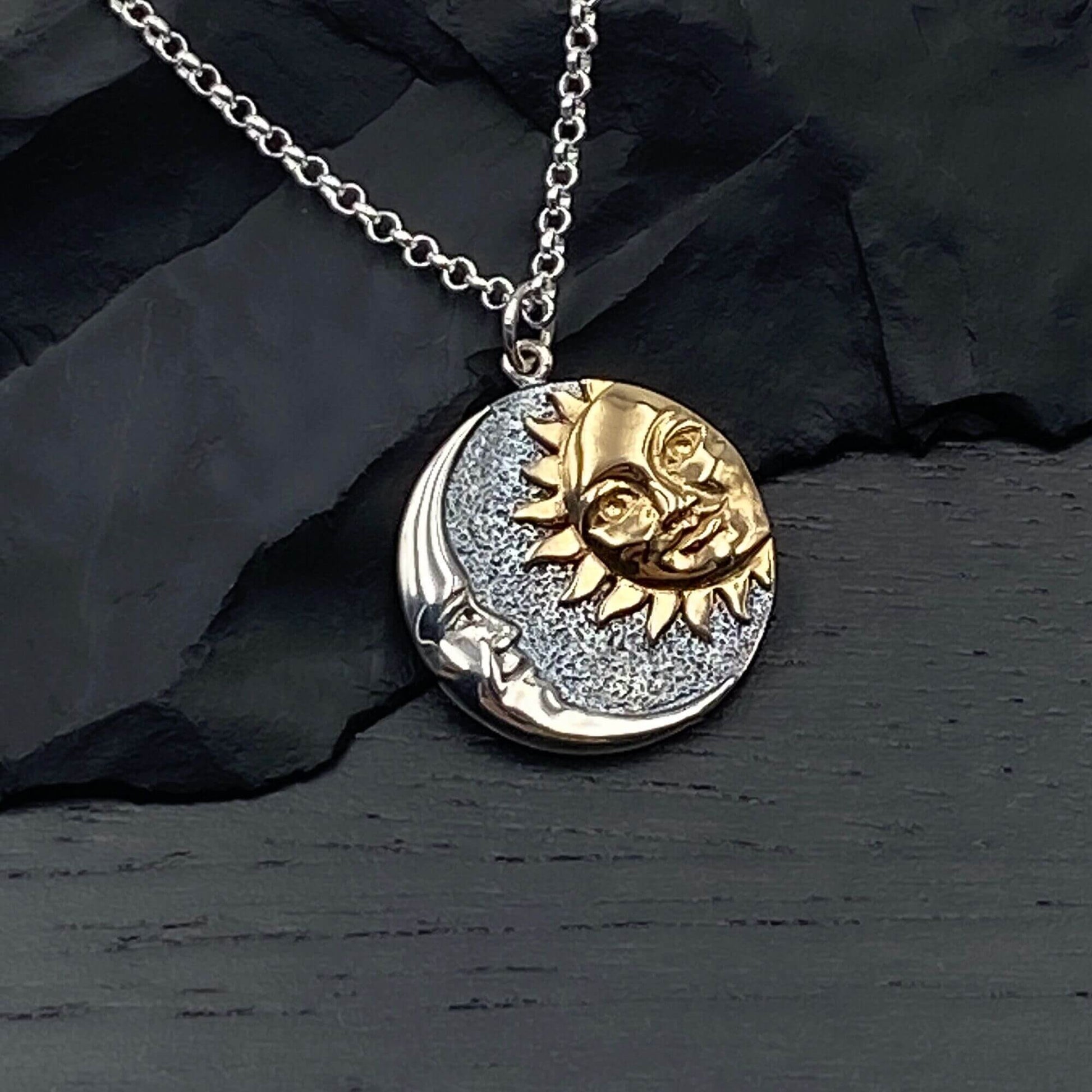 Round shaped silver mixed metal sun and moon pendant on a sterling silver chain.