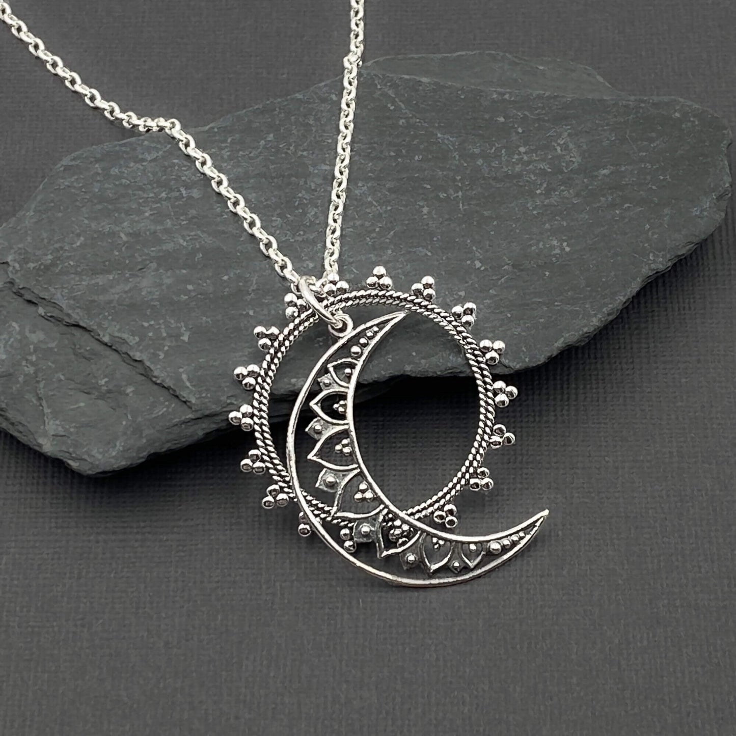 Sun and Moon shaped openwork silver dual dangling pendants on a sterling silver chain.