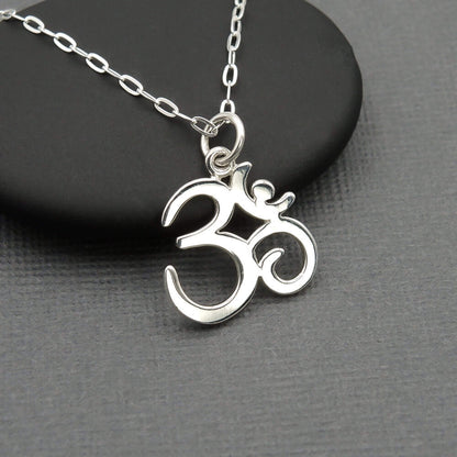 Ohm symbol script shaped silver petite Hindu charm on a sterling silver chain.