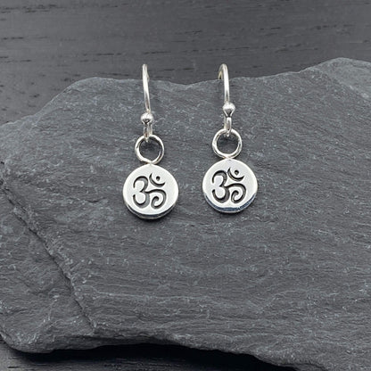 Sterling silver circular earrings on silver hook ear wires with a spiritual Om symbol design.