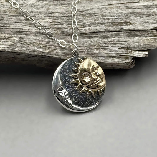 Round shaped silver mixed metal sun and moon pendant on a sterling silver chain.