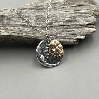 Round shaped silver mixed metal sun and moon pendant on a sterling silver chain.