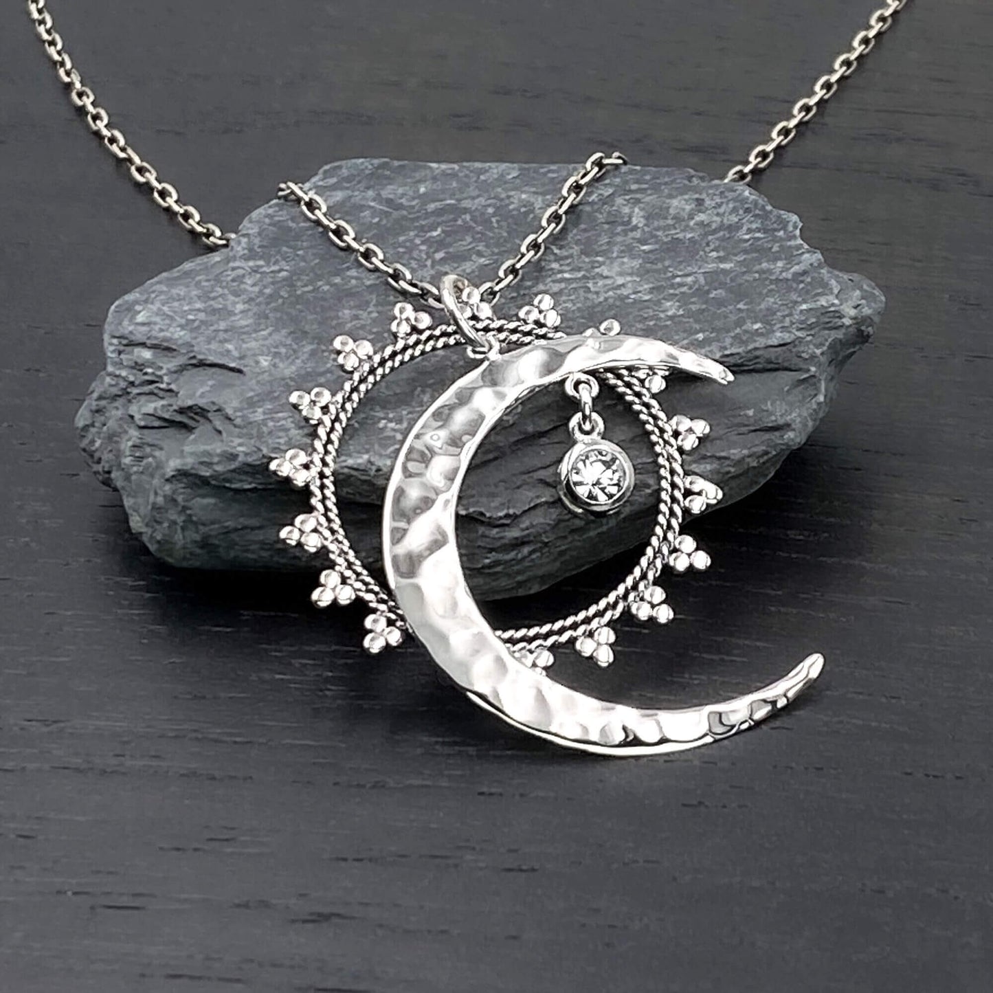 Sterling silver Celestial necklace with three components, a hand hammered crescent moon, a bohemian mandala and a dangling clear crystal charm all interdependent of each other. 