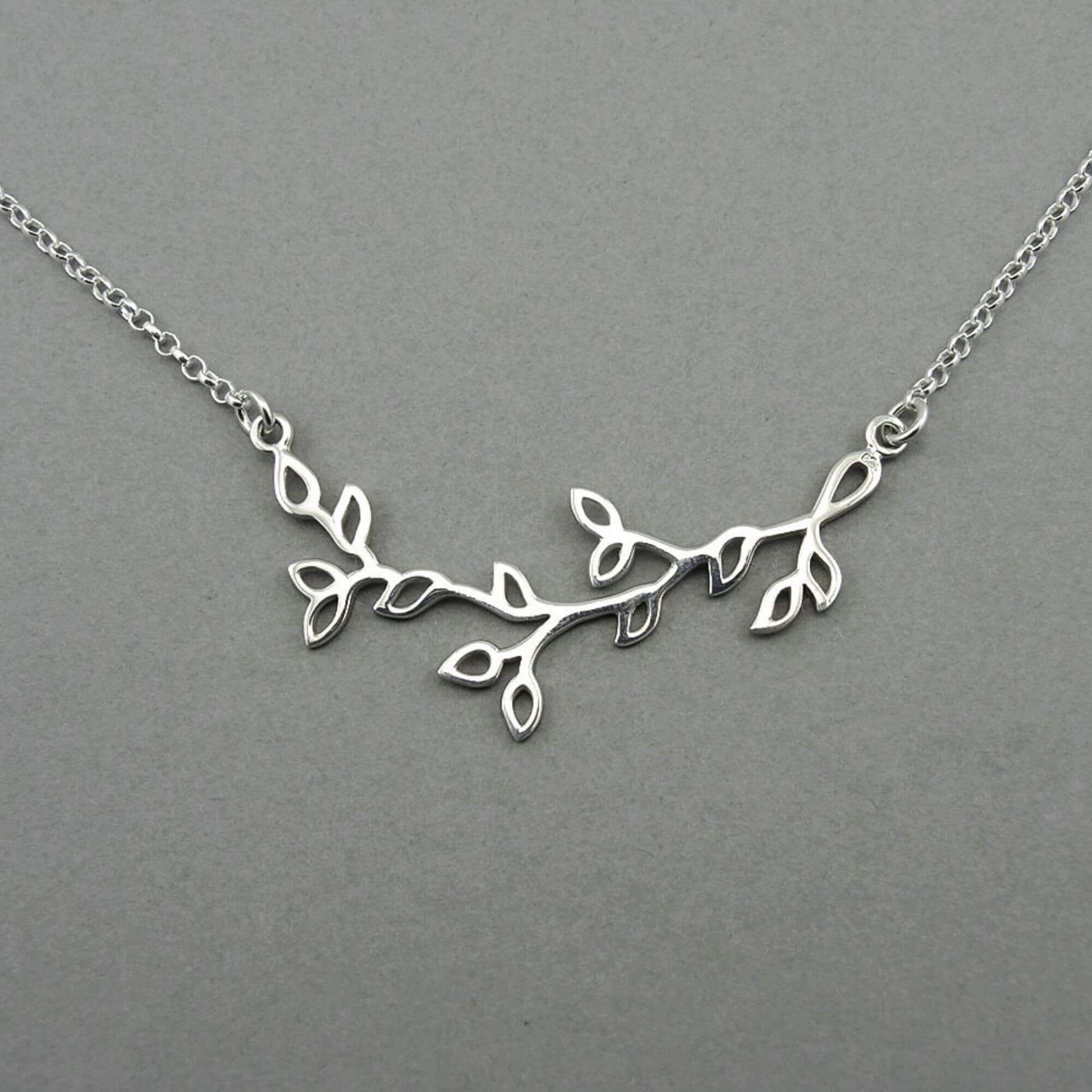 Tree branch shaped silver floating pendant on a sterling silver chain for women.