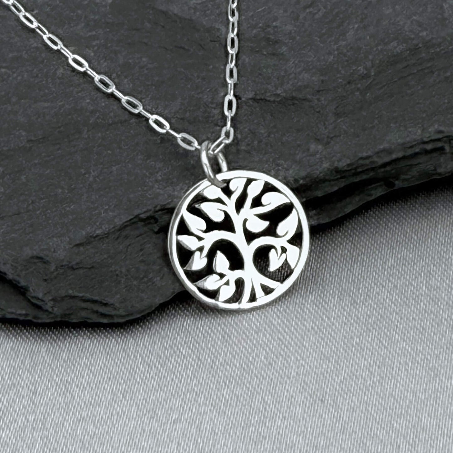 Silver tiny tree charm necklace for women with a 925 solid sterling silver cable chain.  The small, round Tree of Life charm features an openwork cut-out style. Perfect for nature lover gifts for a woman. The silver round tree charm is about 1/2" tall.