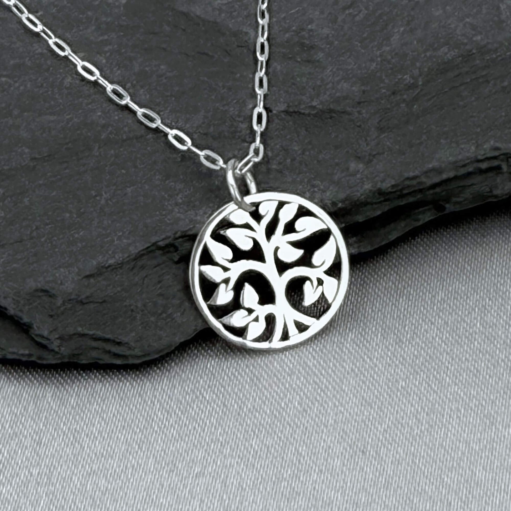 Silver tiny tree charm necklace for women with a 925 solid sterling silver cable chain.  The small, round Tree of Life charm features an openwork cut-out style. Perfect for nature lover gifts for a woman. The silver round tree charm is about 1/2" tall.