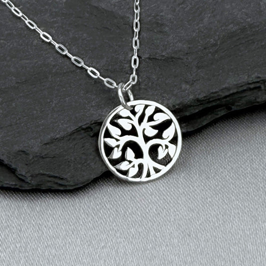 Silver tiny tree charm necklace for women with a 925 solid sterling silver cable chain.  The small, round Tree of Life charm features an openwork cut-out style. Perfect for nature lover gifts for a woman. The silver round tree charm is about 1/2" tall.