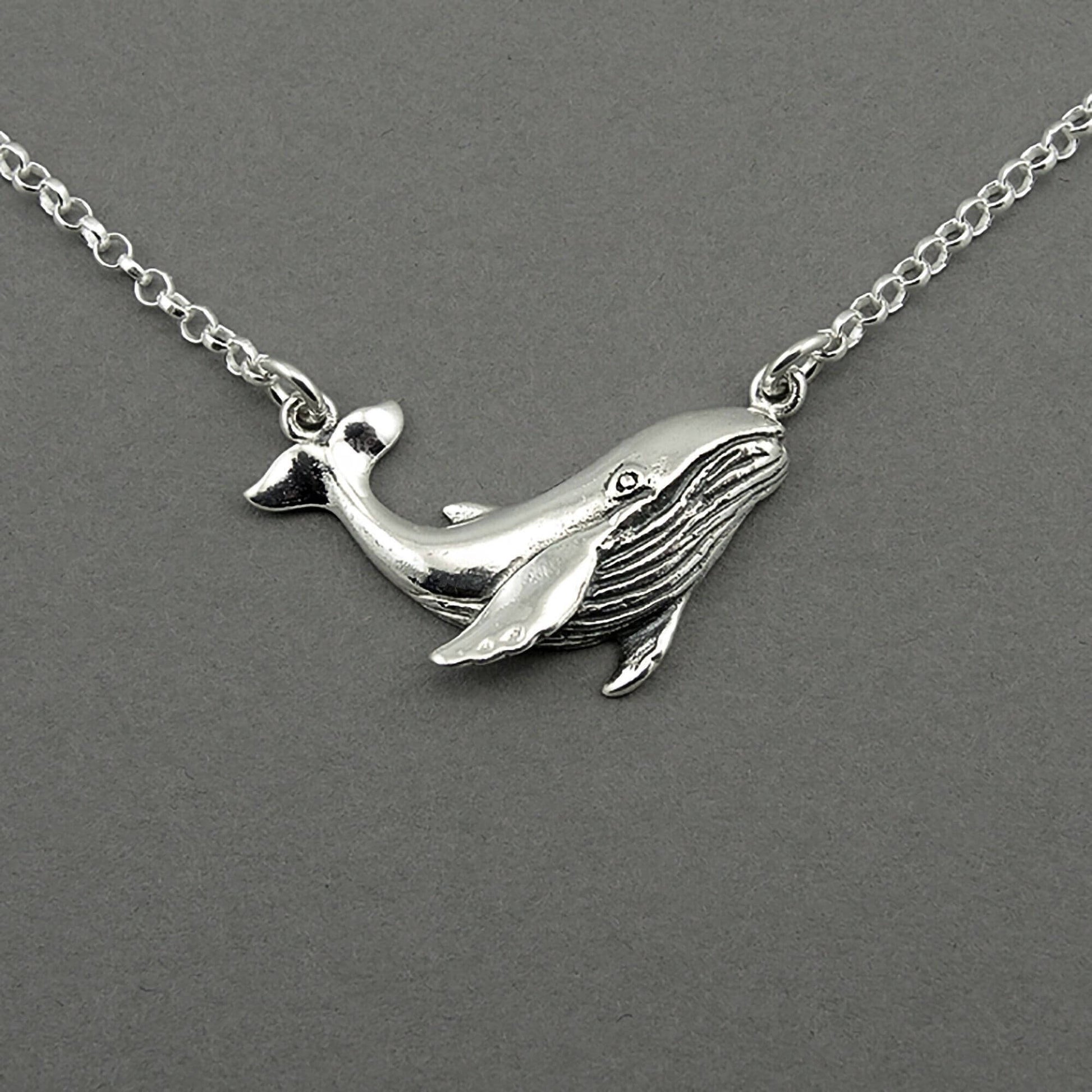 Sterling silver humpback whale pendant floating on the silver chain.  The whale is detailed.